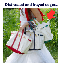 Load image into Gallery viewer, “Boatkin” Canvas Tote Bag w/ Gold Buckle Hardware - ivory with navy trim